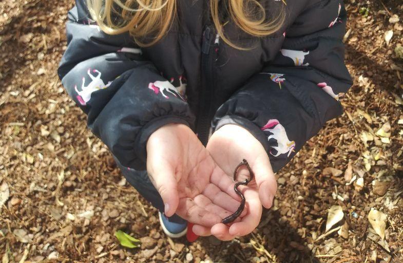 student holding a worm
