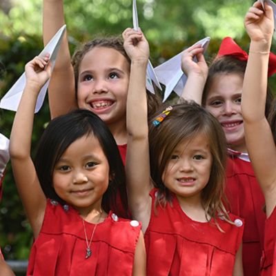 lower school students with paper airplanes